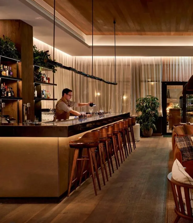 Long bar with a timber ceiling and bar stools